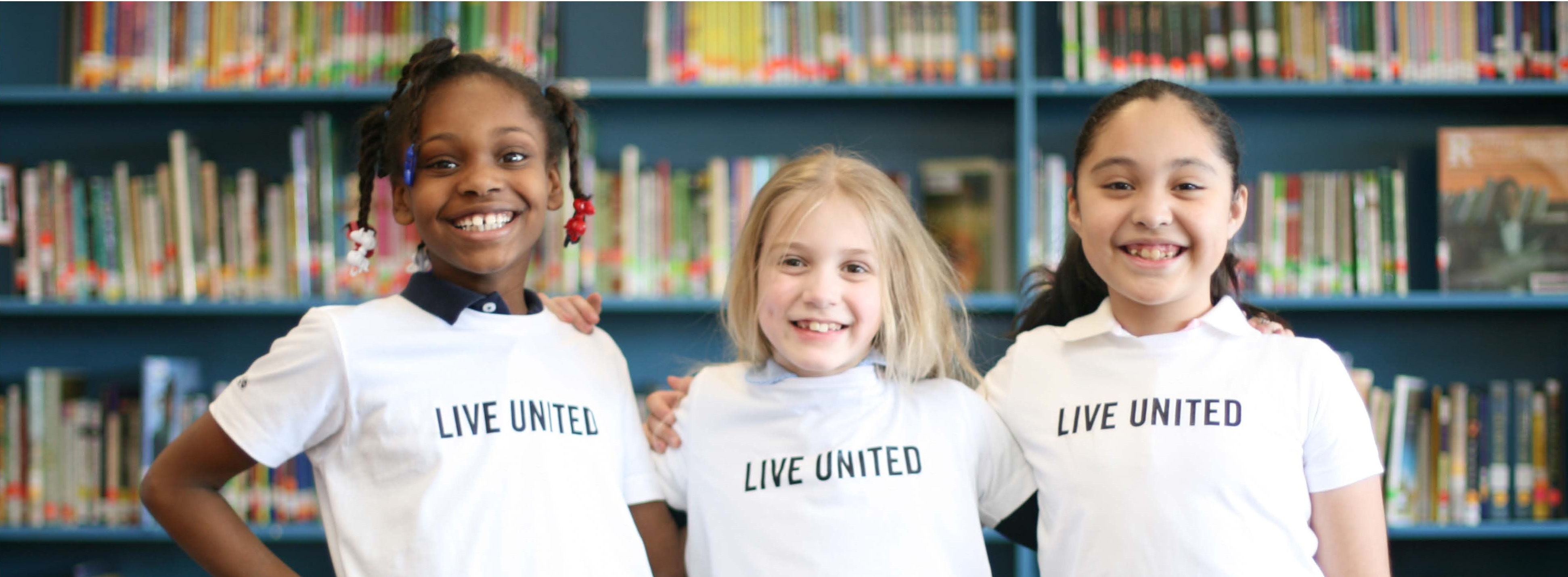 Kids standing together wearing Live United shirts