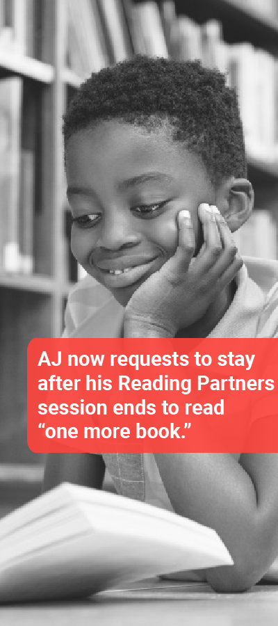 black and white photo of a young boy smiling, reading in a library. caption says "aj now requests to stay after his reading partners session ends to read one more book"