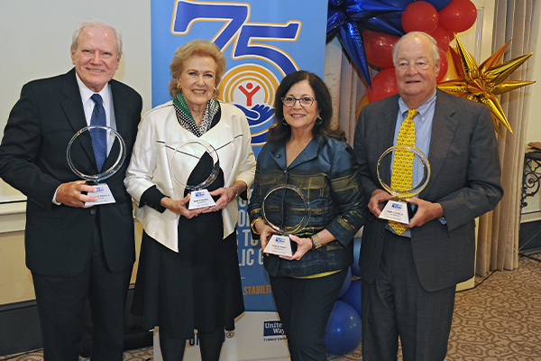 A photo of Charles W. Patrick, Jr., Nella G. Barkley, Anita G. Zucker and Hugh C. Lane, Jr. accept their recognition at the March 16, 2022 Forever United event held in their honor.