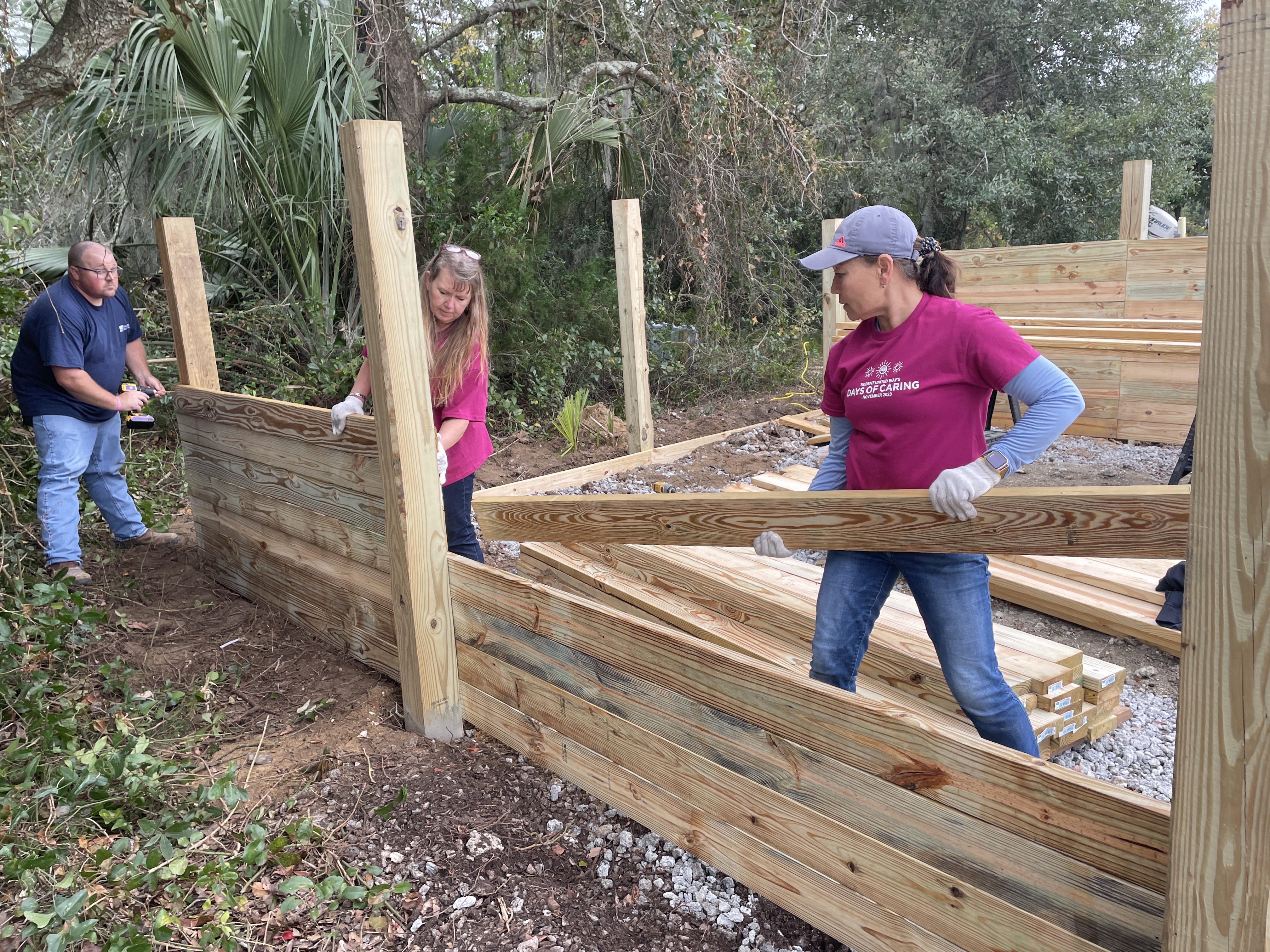 A group of volunteers builds a structure with wood for Days of Caring.