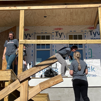group of volunteers helping to build a house for habitat for humanity