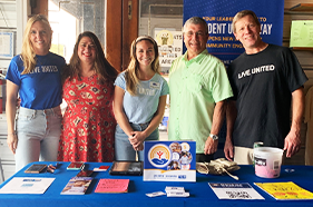 Group of Trident United Way staff members at a fundraising table for fundraising event at Tradesman Brewery