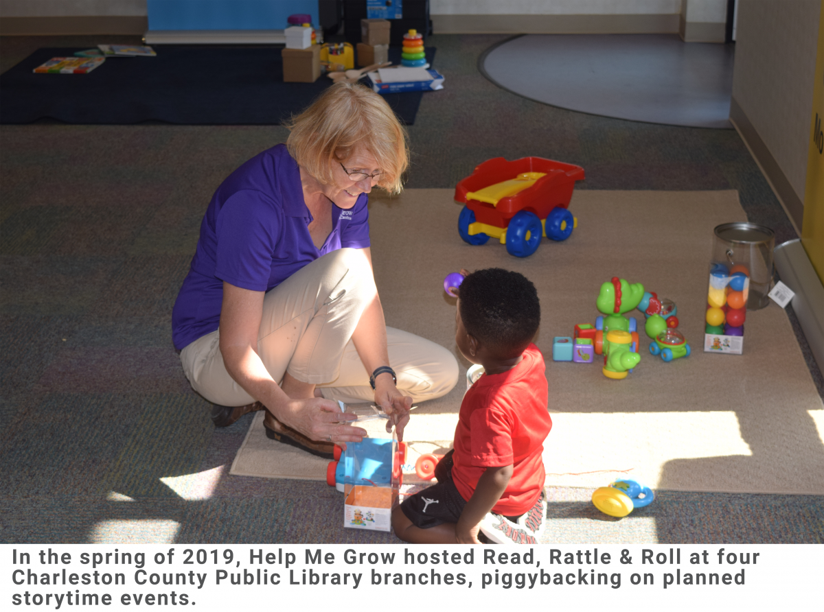 Volunteer and little boy playing with toys