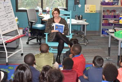picture of volunteer reading at Dunston Elementary
