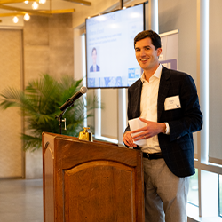 Travis Frank speaks at Mix and Mingle event