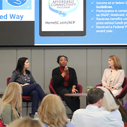 Photo of three women panelists on stage