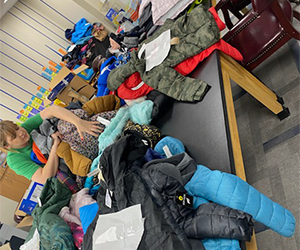 Photo of woman at Harleyville Elementary School looking through donated coats