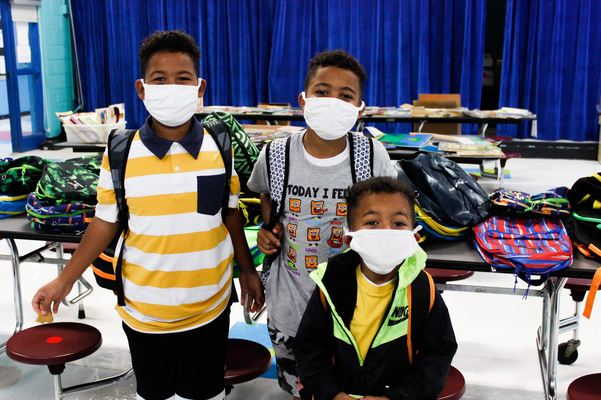 joseph, benjamin and joshua robinson with donated backpacks