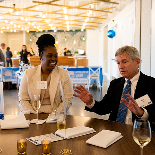 Peter Burrous speaks with a Young Leaders United member at Mix and Mingle event