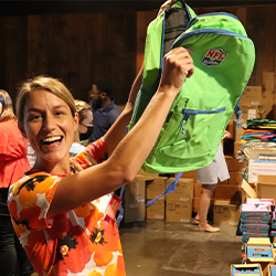 Bailey Cooper holds up a backpack at the 2021 Backpack to School Bash