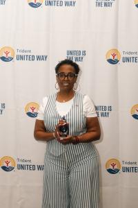 Dr. Aretha Polite-Powers, Nonprofit Leader of the Year, posing with award in front of step and repeat