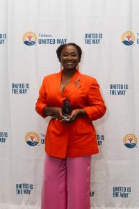 Kenya Dunn, Role Model of the Year, posing with award in front of step and repeat