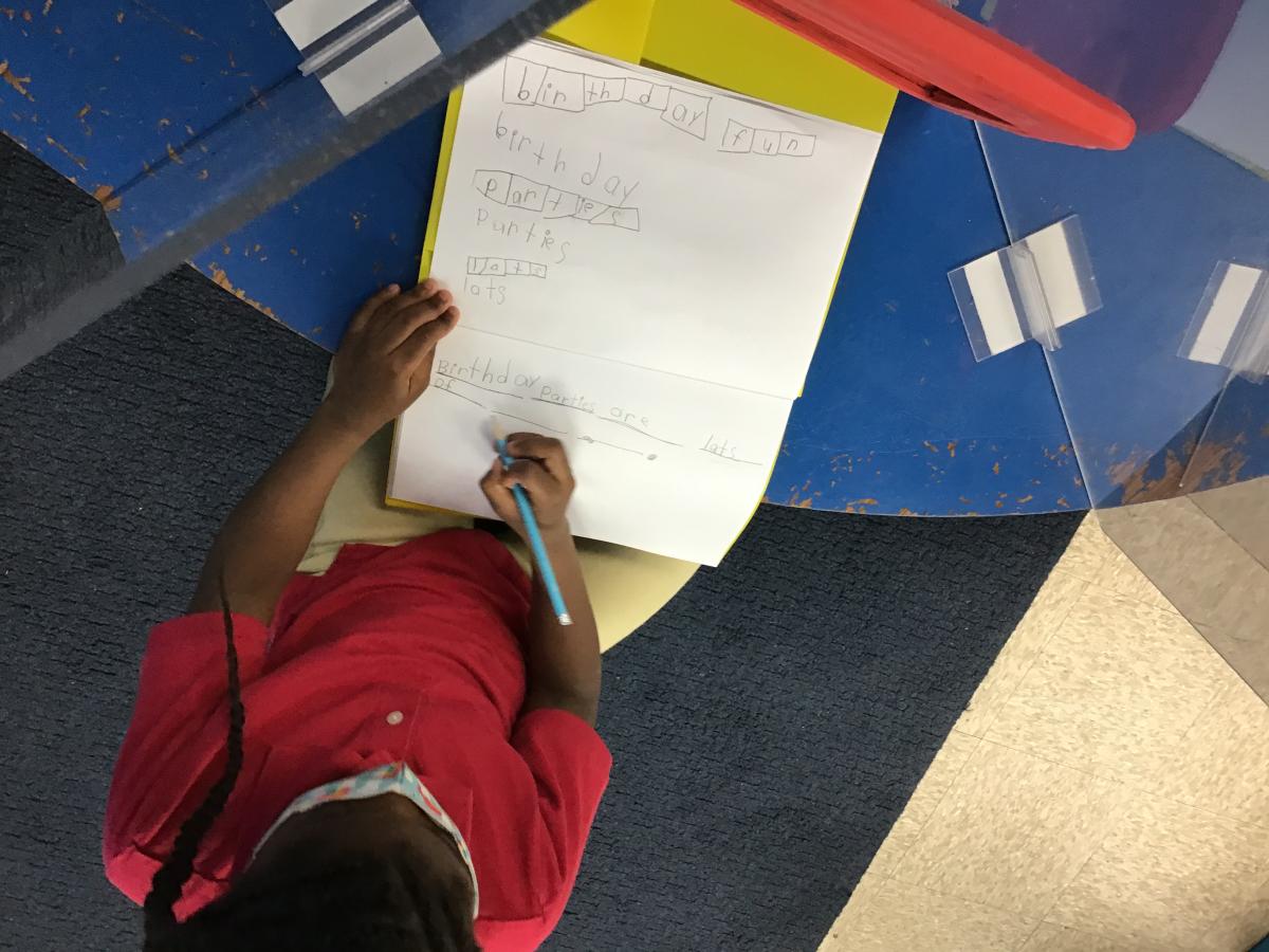 student working on elkonian board in classroom
