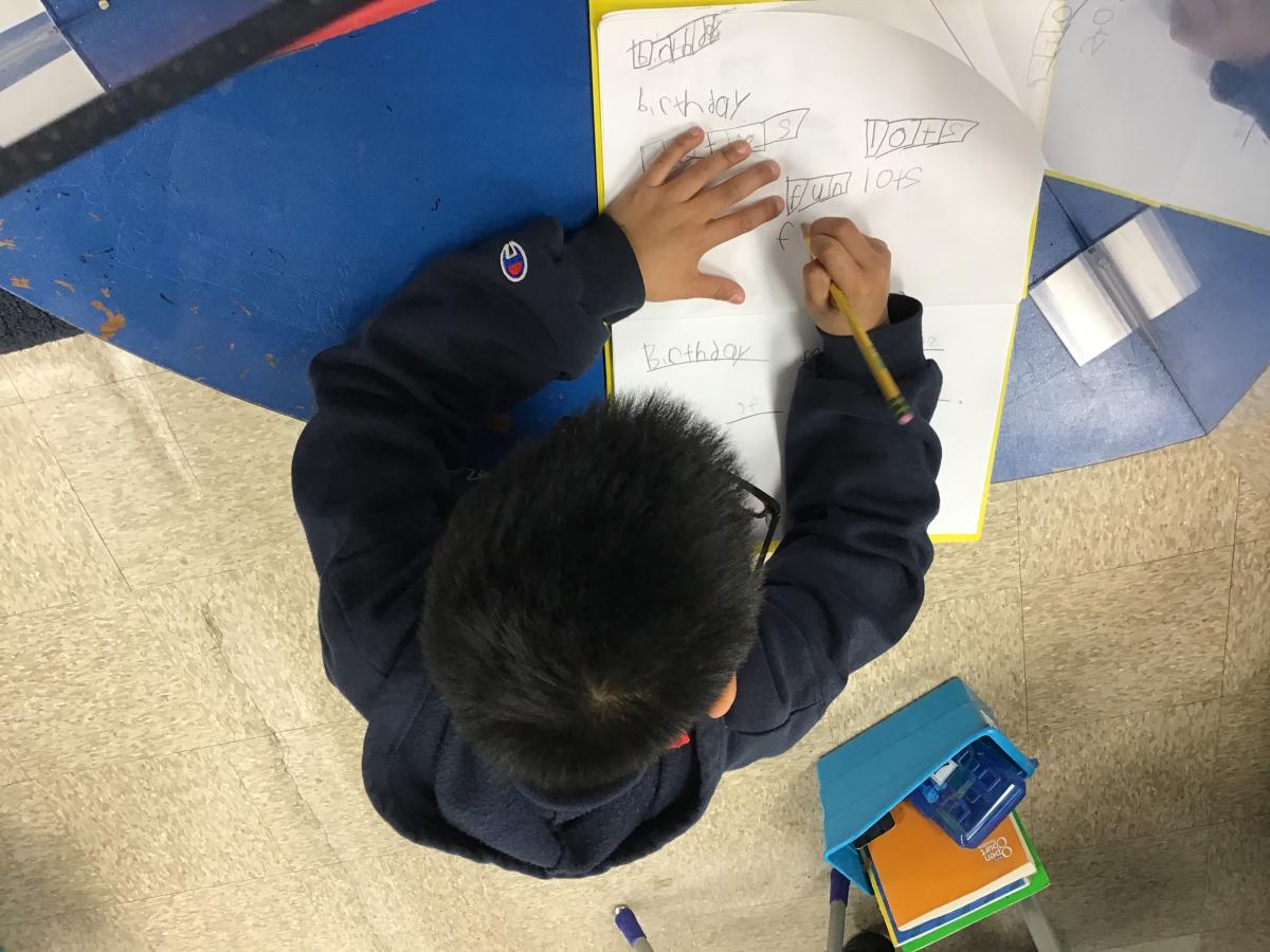 student working on elkonian board in classroom