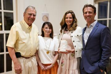 Photo from event of Bob and Christina Brinkman, Valerie and Scott Howell. Valerie is holding a sculpture Ms. Brinkman made and gifted as the Alexis de Tocqueville Award.