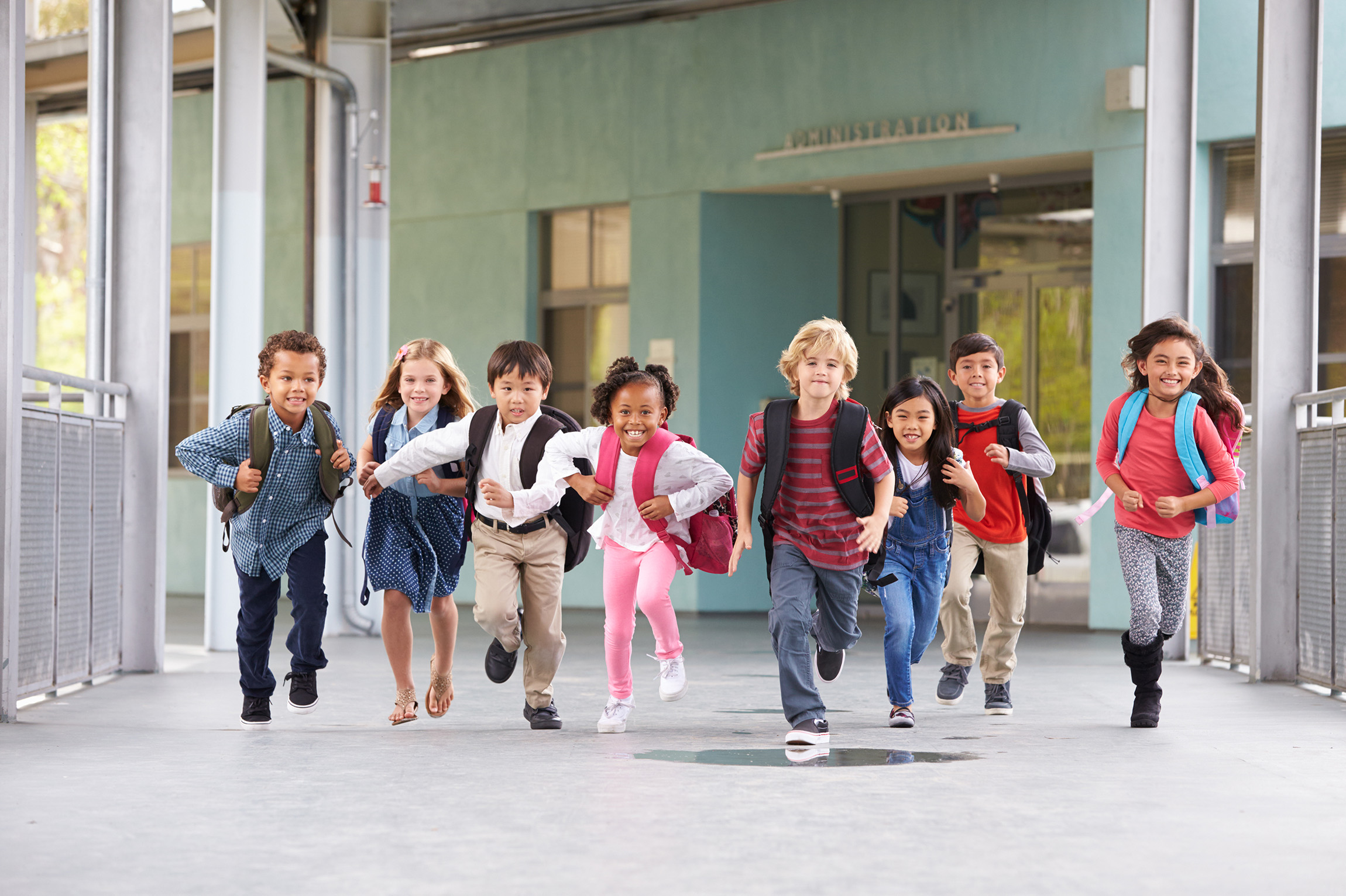 group of kids running in school