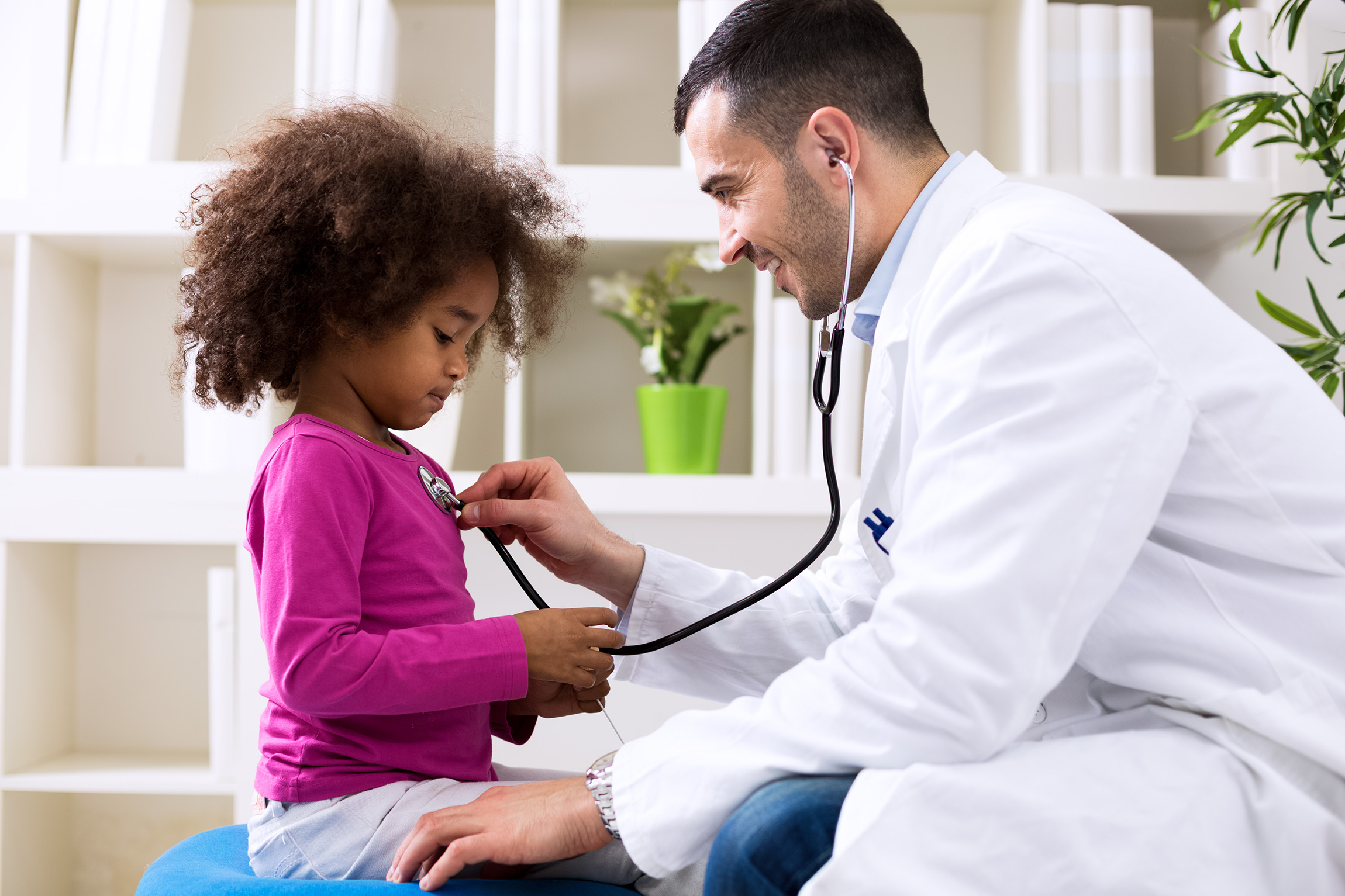 doctor using stethascope on girl