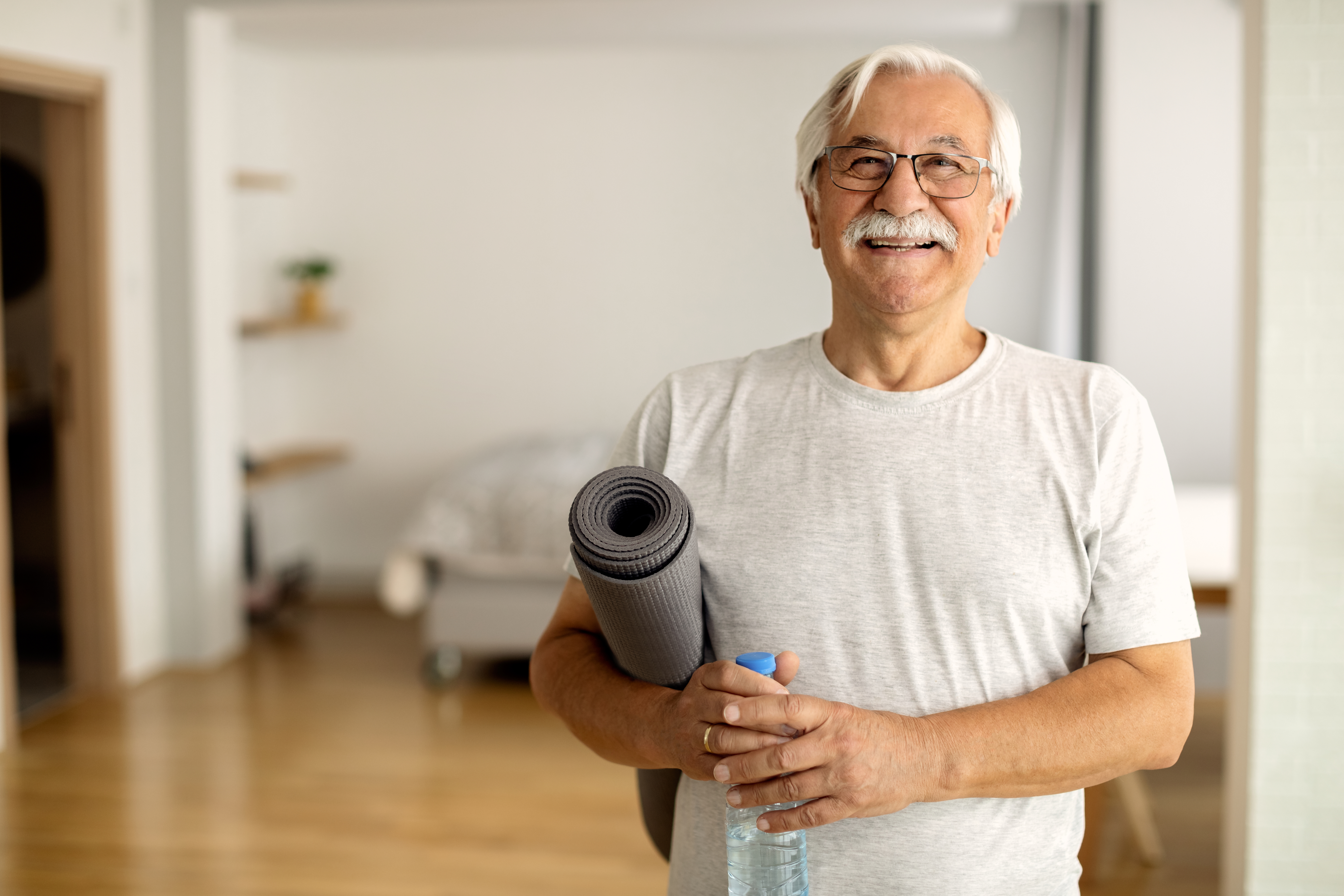 adult holding yoga mat