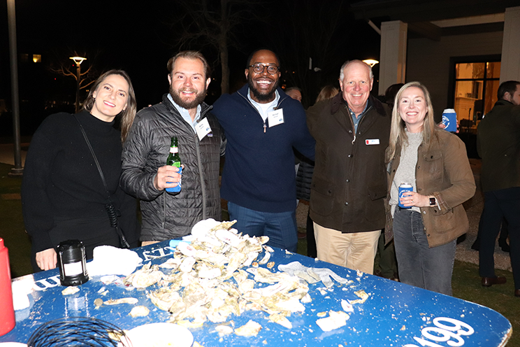 A group of Palmetto and Tocqueville Society Members stand behind a table of Oysters at this annual event.