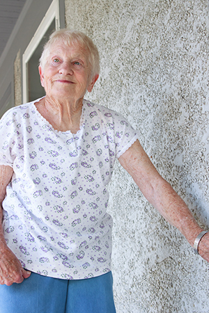 Elderly woman standing outside