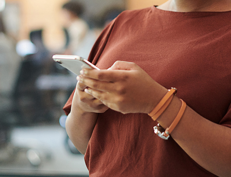 woman typing on smart phone