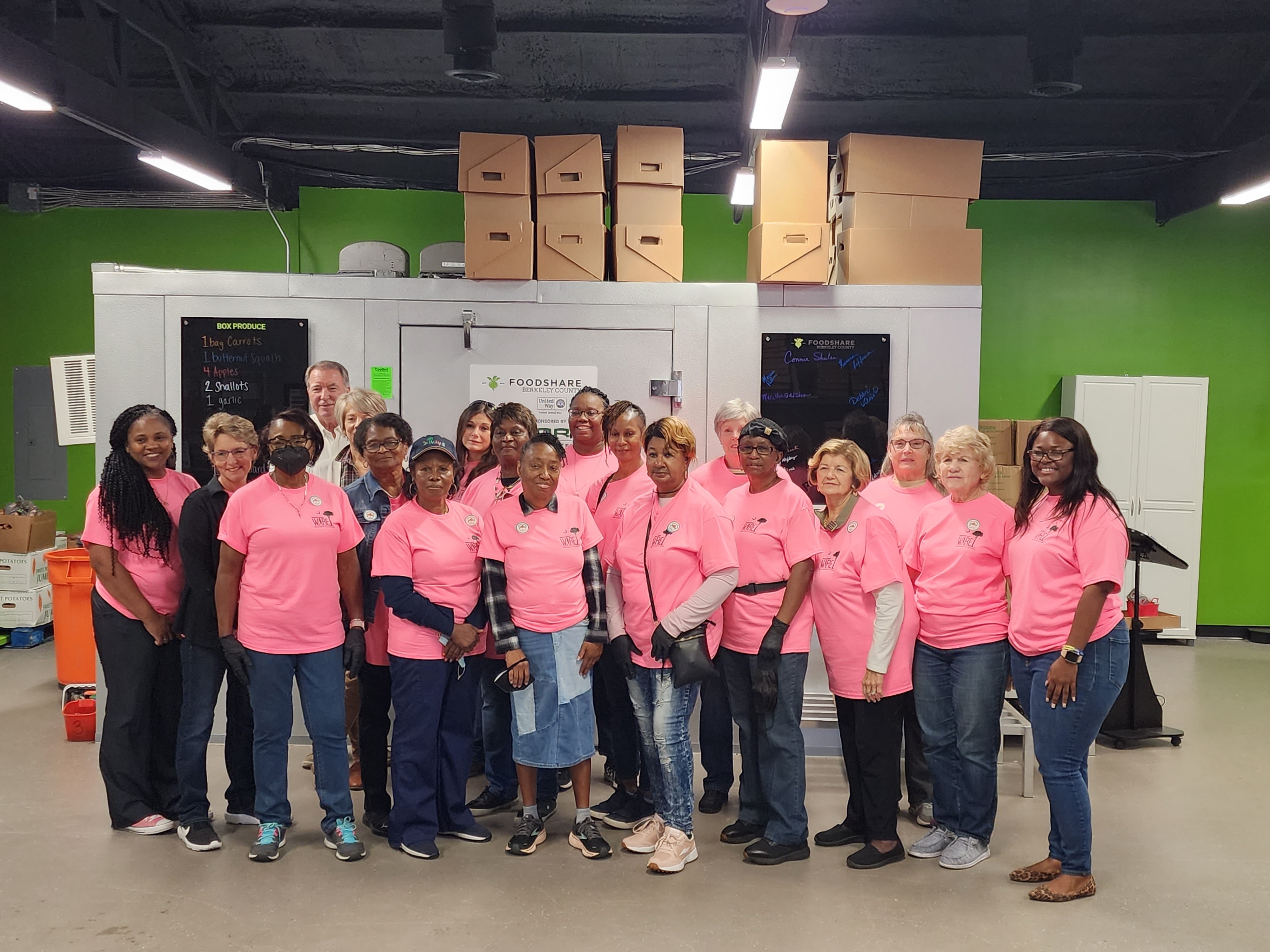 Group of volunteers stands in front of the coolbot at FoodShare Berkeley County