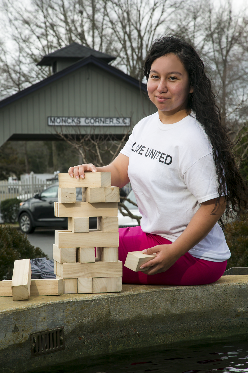 Alex Headshot with jenga blocks