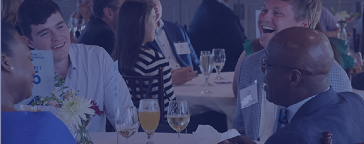 A group sits at a table at the Cocktails and Conversations Event.
