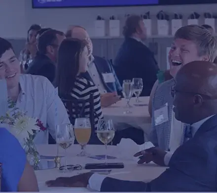A group sits at a table at the Cocktails and Conversations Event.