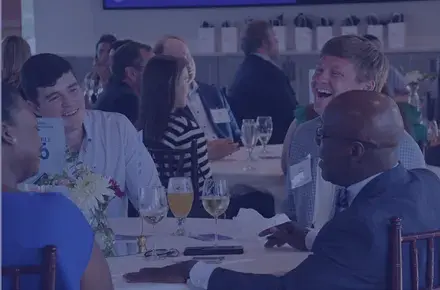 A group sits at a table at the Cocktails and Conversations Event.