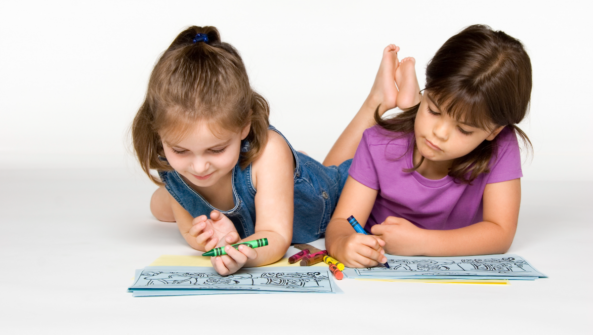 two young girls coloring
