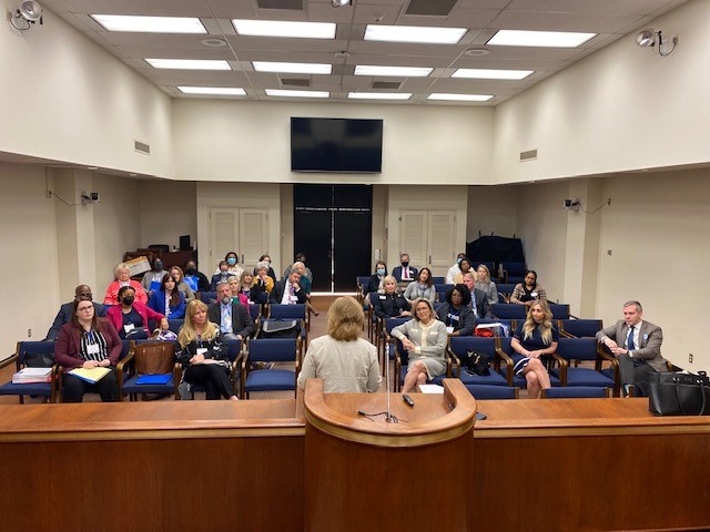 UWASC meets with legislature in a room at the state house, the group sits lecture hall style
