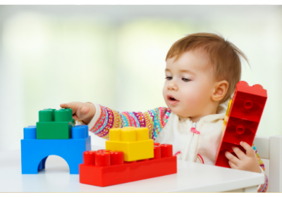 baby playing with large lego blocks