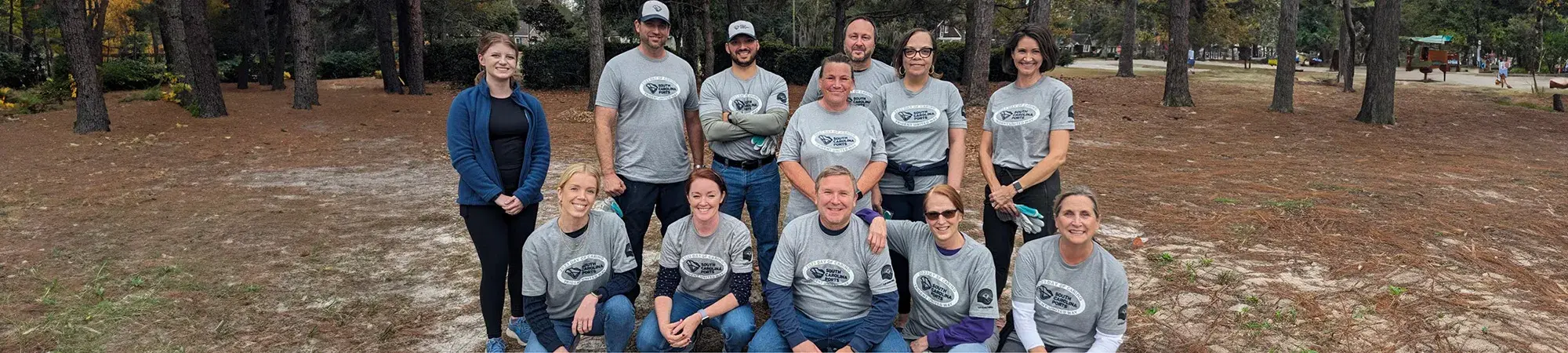 Corporate partner volunteer group posing for photo outside