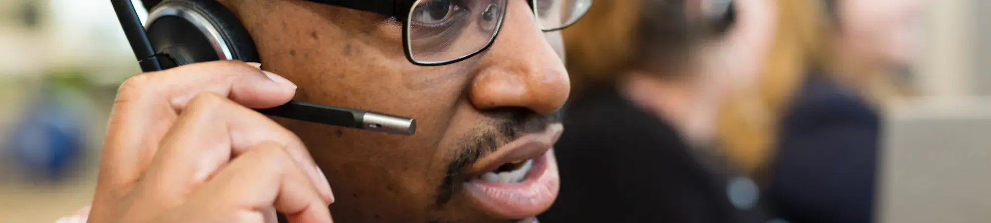Man in call center speaking into headset