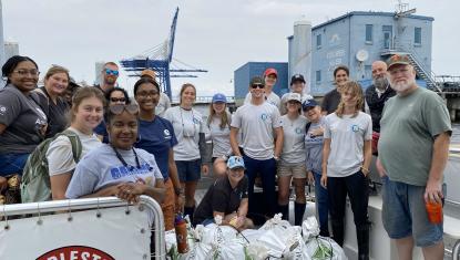 AmeriCorps volunteers with Sustainability Institute Environmental Conservation Corps on boat.