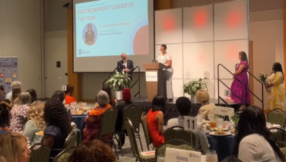 A photo of an award winner on stage at the Women United Awards Luncheon.